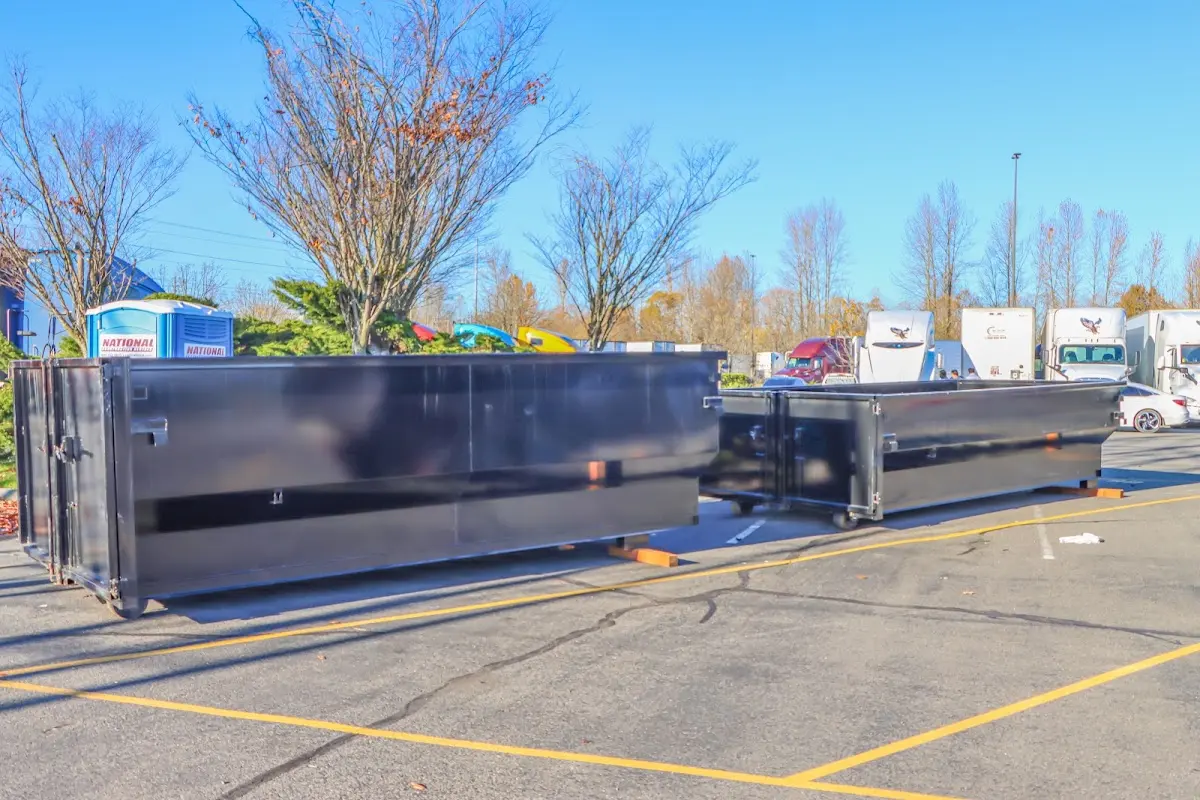 Professional dumpster rental service with roll-off container on residential driveway in Windsor Heights